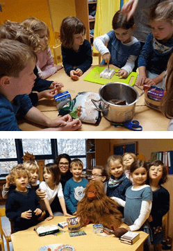 Einige Kinder beugen sich gespannt über einen Tisch, ein Kind schneidet etwas auf einem Schneidebrett. (oben) Die Kinder der KiTa stehen für ein Gruppenfoto um einen Tisch, auf dem das Orang-Utan-Plüschmaskottchen Ginting sitzt. (unten)