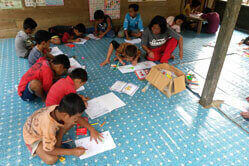 Children sitting on the floor learning.