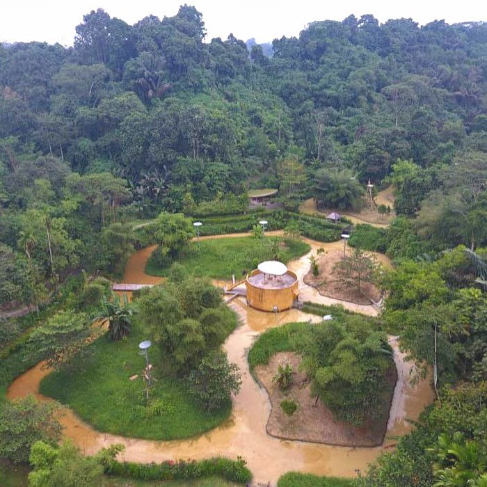 Dronenaufnahme von vier Orang-Utan-Inseln. Im Zentrum der Inseln befindet sich eine Orang-Utan-Unterkunft. Sie ist auf dem Wasser gebaut und mit allen vier Inseln verbunden.